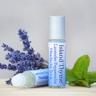 product - lavender peppermint headache stick with lavender and mint leaves