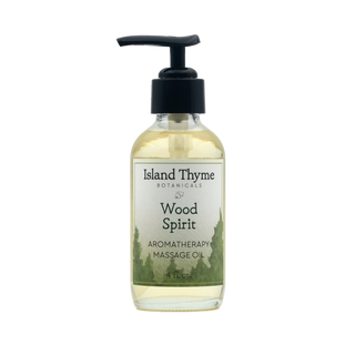 A clear 4 fl. oz. bottle of Wood Spirit Aromatherapy Massage Oil with a black pump and green botanical designs, made with essential oils for natural moisturizing.
