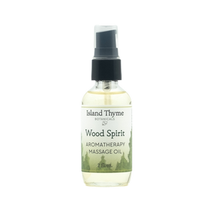 The 2 fl. oz. clear bottle of Wood Spirit Aromatherapy Massage Oil comes with a black pump, green and white label, and essential oils for a soothing, natural moisturizing experience.