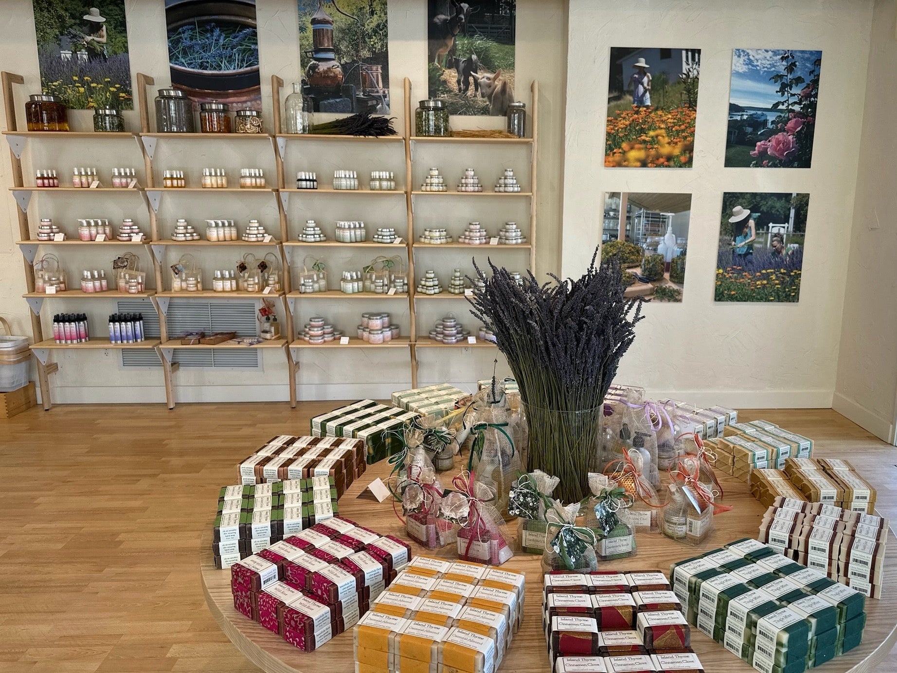 Display of wrapped gifts and decorative items in a store setting with shelves and wall art.