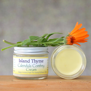 jar of calendula comfrey cream with calendula flower