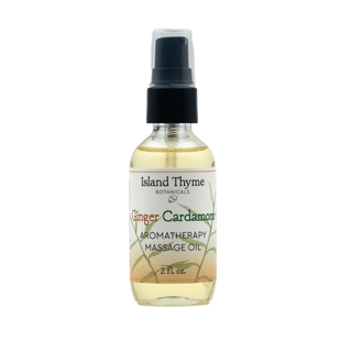 The Ginger Cardamom Aromatherapy Massage Oil 2oz comes in a black-capped spray bottle with a clear label featuring green and orange accents, infused with ginger essential oil for natural moisturization.